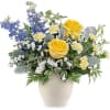 Bright yellow roses meet tall blue delphinium spikes in a lively, garden-style