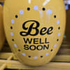 Yellow vase with "Bee Well Soon" text and polka dots