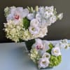 this design features 2 arrangements with white and green hydrangea, dianthus, orchids