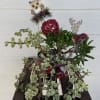 Potted succulent arrangement with holiday owl and reindeer decorations