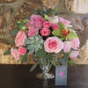 Pink rose bouquet in a silver vase with succulents and greenery