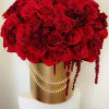 Large bouquet of red roses in a gold box with pearl strands
