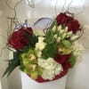 Designer arrangement of gorgeous roses, tulips and orchids in a unique heart