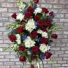 A Red, White and Blue easel tribute filled with red roses, white