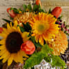 Bouquet of yellow sunflowers, orange tulips, and orange mums