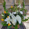 White lilies and yellow roses arranged in a wicker basket