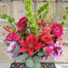 Mixed bouquet with red lilies, pink roses, gerbera daisies, and purple orchids