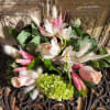 Bouquet of pale pink roses, white orchids, and green hydrangea