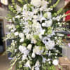 Large white floral standing spray with lilies and roses