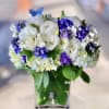 Bouquet of white and purple flowers in a green vase