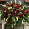 Large arrangement of red roses and white calla lilies