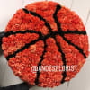 Basketball-shaped arrangement of orange carnations with black accents