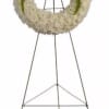 Standing funeral wreath with red roses and white flowers on an easel