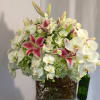 White orchids and pink lilies arranged in a glass vase