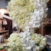 Large white floral heart arrangement with roses and orchids