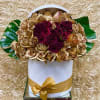 Bouquet of deep red and gold roses in a white hat box with a gold ribbon