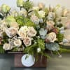 Cream roses and green hydrangeas in a wooden box arrangement
