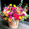 Mixed bouquet of roses, chrysanthemums, and alstroemeria in a peach vase
