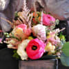 Small mixed bouquet with pink and cream flowers in a square box