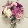 Pink and purple mixed bouquet in a clear glass vase