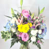Roses, daisies, hydrangeas, lilies and beautiful fillers and greenery arranged in a
