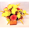 Yellow and coral flowers arranged in an orange square vase
