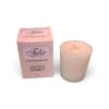 Pink boxed votive candle beside a cream candle