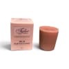 Pink boxed votive candle beside a brown candle