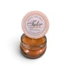 Orange candle in a glass jar with a round lid