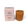 Pink boxed votive candle beside a brown candle