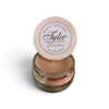 Small scented candle in a glass jar with a round lid label