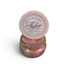 Pink scented candle in a glass jar with a round lid