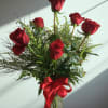 6 Red roses traditionally designed in a glass vase with filler and
