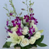 White roses and lilies with purple orchids in a wooden box