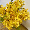Yellow orchid bouquet with speckled petals and green buds