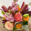 In the clear glass, square vase combinations or orange flowers lilies, marigold