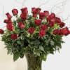 Beautiful long-stemmed red roses presented in a high quality clear glass or