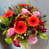 Bouquet of pink roses, orange gerbera daisies, and lilies