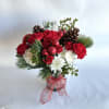 This arrangement is set in a ceramic container, with red roses, hanging