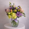 This cheerful and refined floral arrangement is a lively mix of color