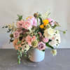 A mix of summer flowers surrounding gorgeous blooming peonies.