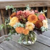Autumnal flower arrangement in a glass vase with beautiful seasonal flowers like