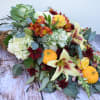 Autumn bouquet with lilies, roses, and small pumpkins