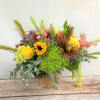 Bright mixed bouquet in a gold vase with yellow and pink blooms