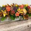 Autumn floral arrangement in a rectangular wooden box with roses and orchids