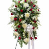 Standing floral spray of red roses and white chrysanthemums with a white ribbon