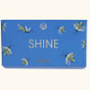 Blue gift box with butterfly illustrations and the word SHINE