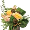 Bouquet of peach roses and pink flowers in a brown vase