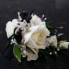 White rose corsage with black and gold ribbon accents