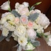 White and blush bouquet with roses, ranunculus, and lisianthus